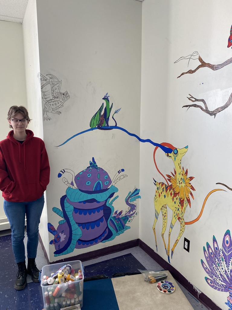 Emily Skinner painting a mural
