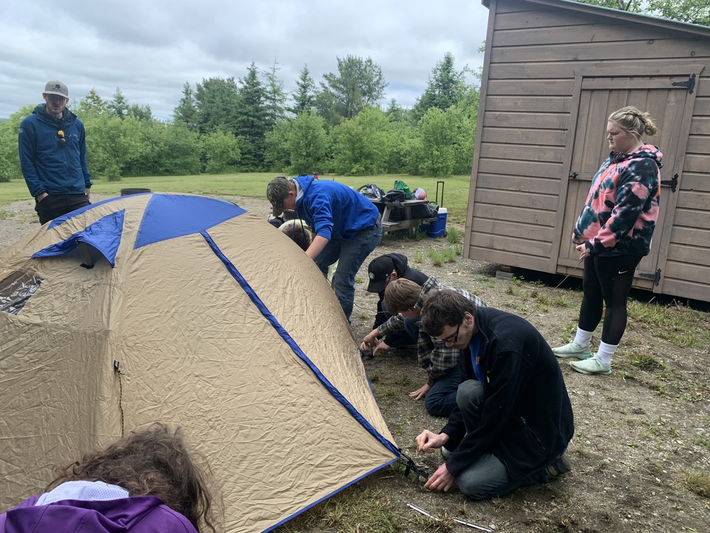 students putting up tents